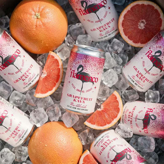 Cans of Flamenco grapefruit kava cocktail cans with grapefruits in a metal bowl.