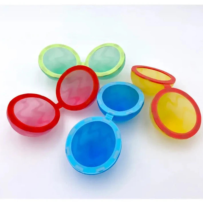 A group of silicone reusable water balloons in red, green, blue, and yellow colors