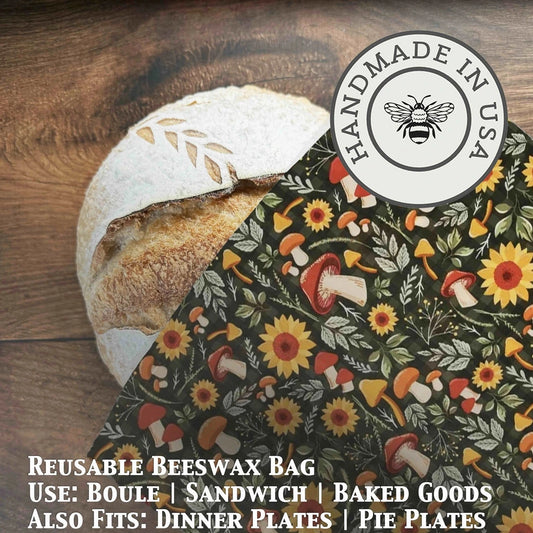 Reusable beeswax bag with autumn mushroom pattern on a wooden surface, featuring a 'Handmade in USA' label.