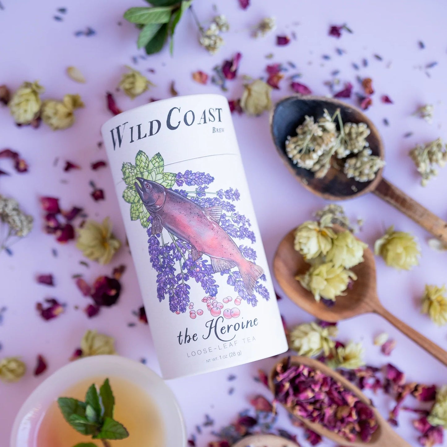 Wild Coast tea can with floral and herbal elements on a light background