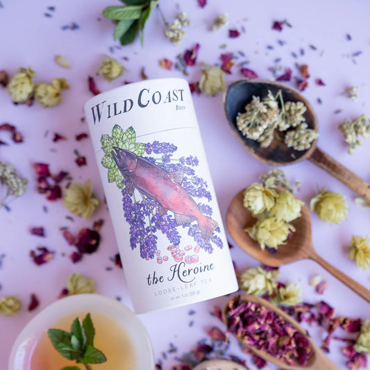 Wild Coast tea can with floral and herbal elements on a light background