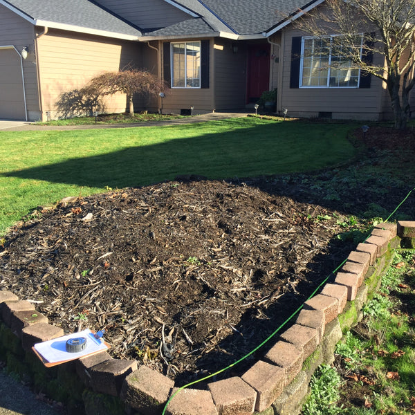A front yard being measured by a tape measure and a clipboard, representing the landscape design consultation raffle item donated by Garden Project Academy 