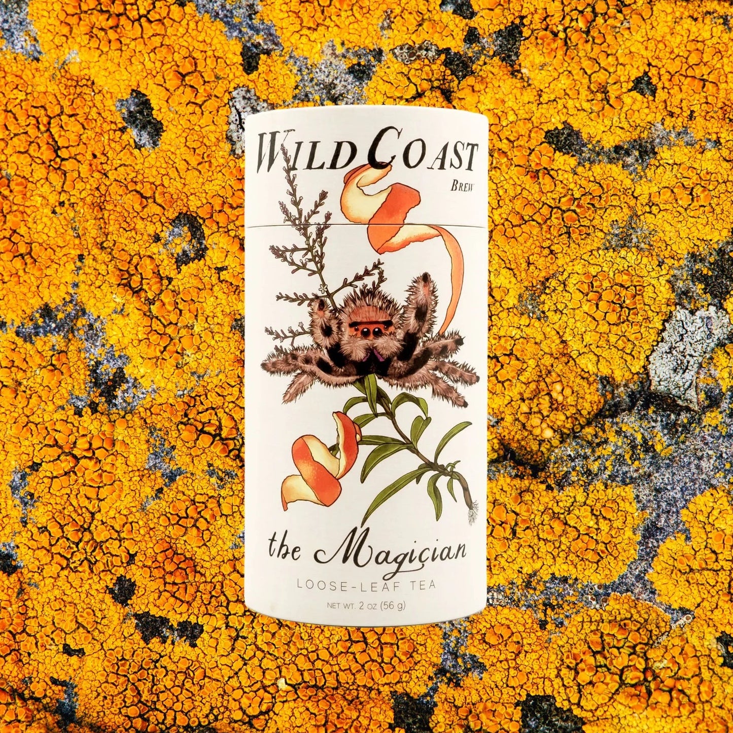 Wild Coast tea container label on a lichen-covered rock background