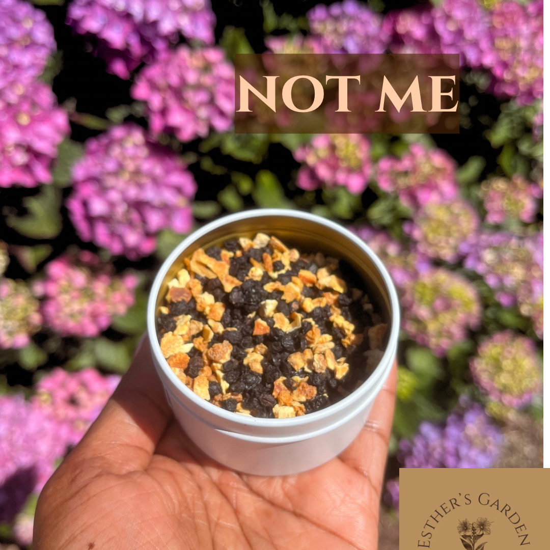Hand holding a small container of soil with seeds against a background of pink flowers, with text 'NOT ME' and 'Esther's Garden' branding.