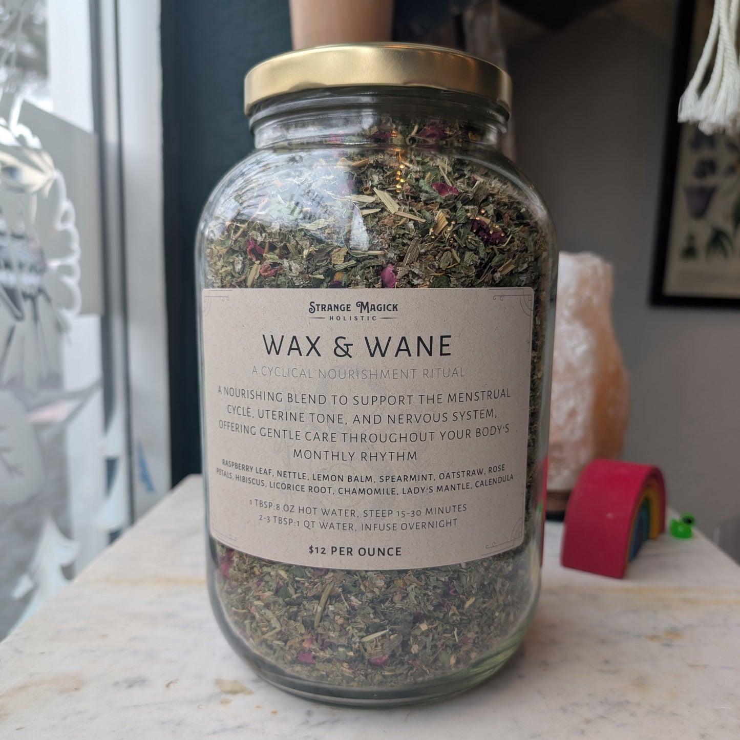 Glass jar with a label on a surface, containing custom tea blend