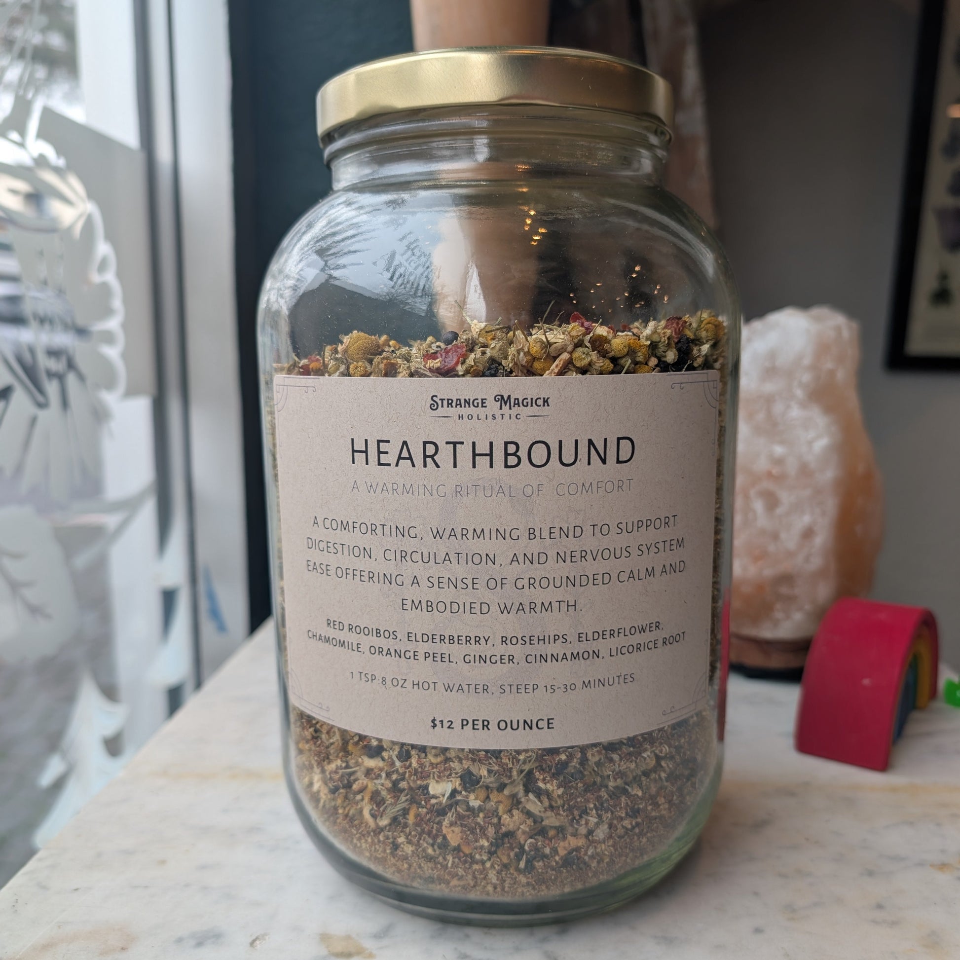 Glass jar labeled 'Hearthbound' filled with custom tea blend