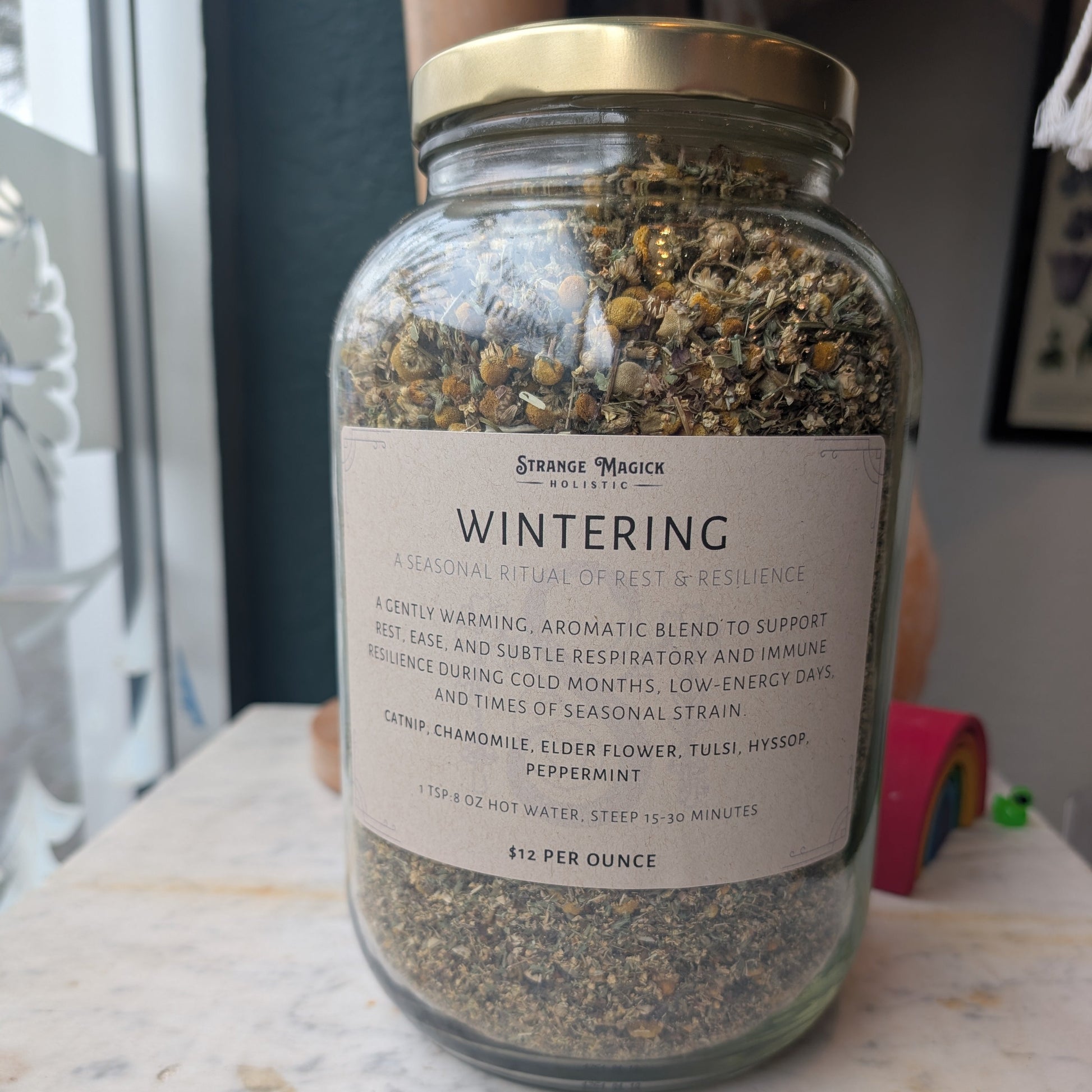 Glass jar labeled 'Wintering' filled with custom tea blend