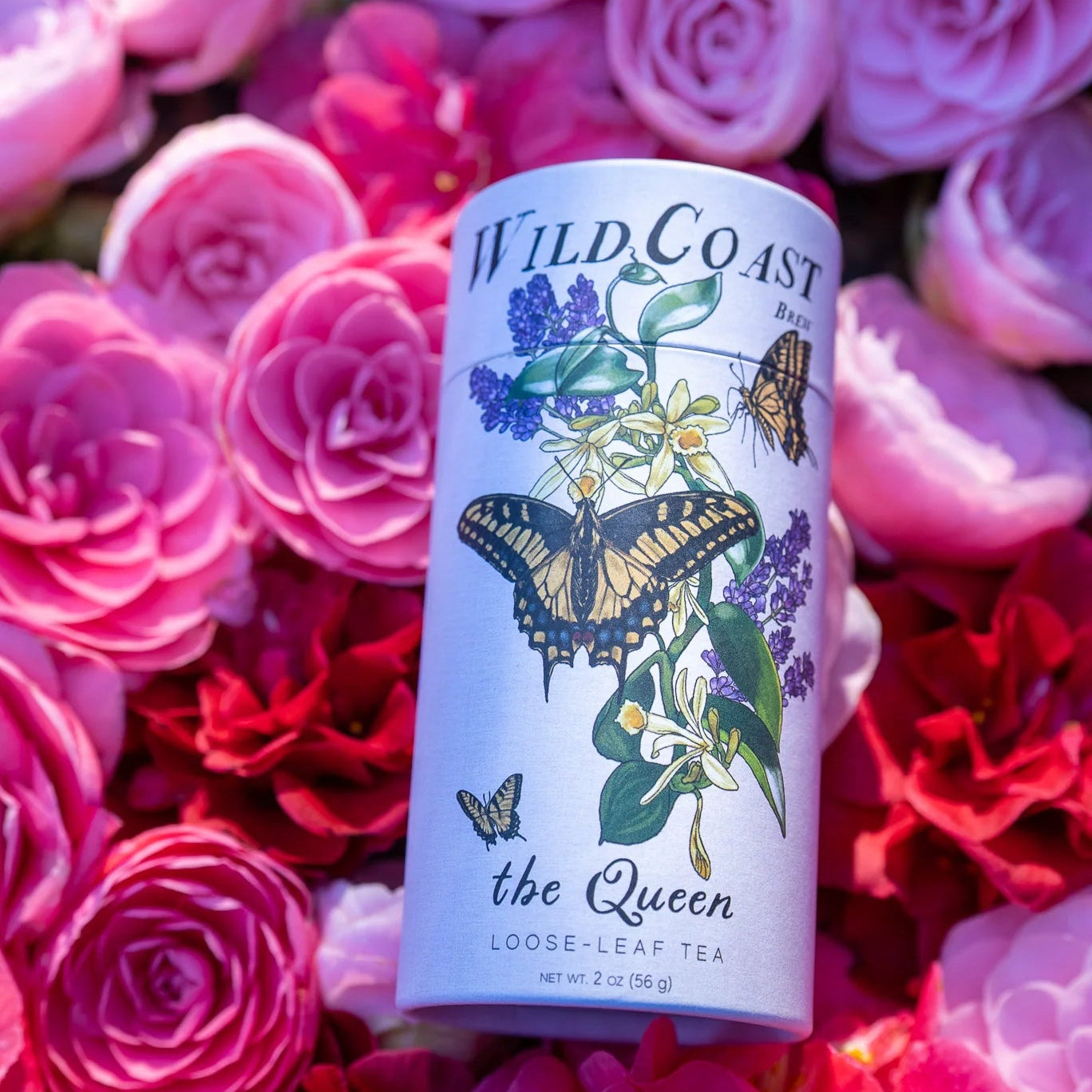 Tea canister with butterfly design on a bed of pink and red flowers