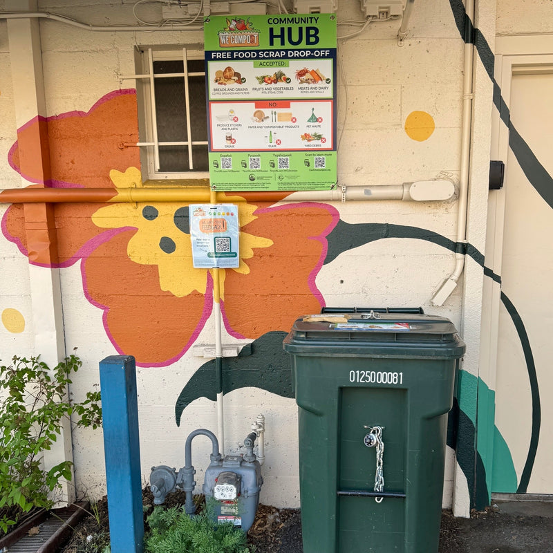 The "we compost" bin behind Kindred waiting eagerly for your food scraps