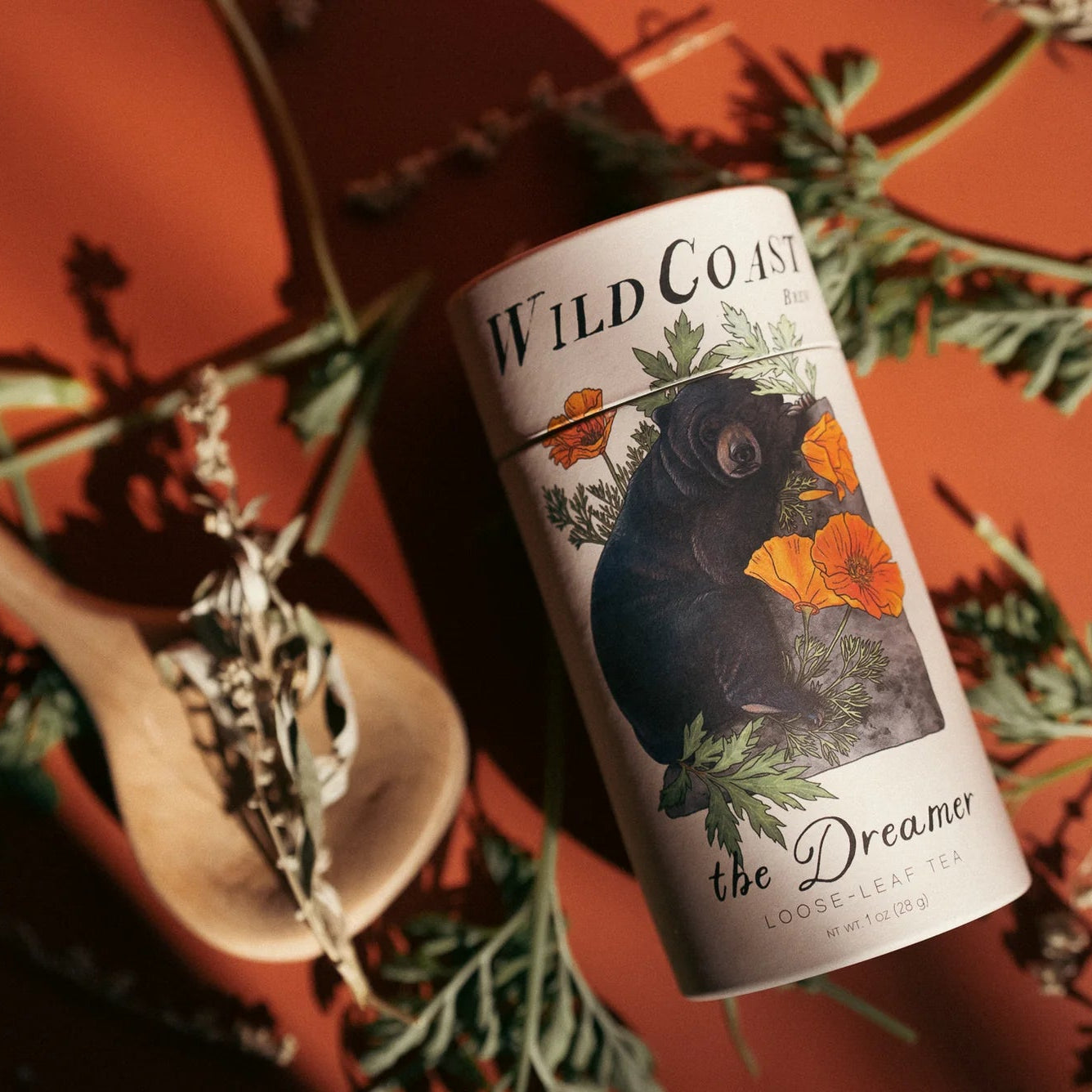 Wild Coast tea canister with decorative elements on a warm-toned background
