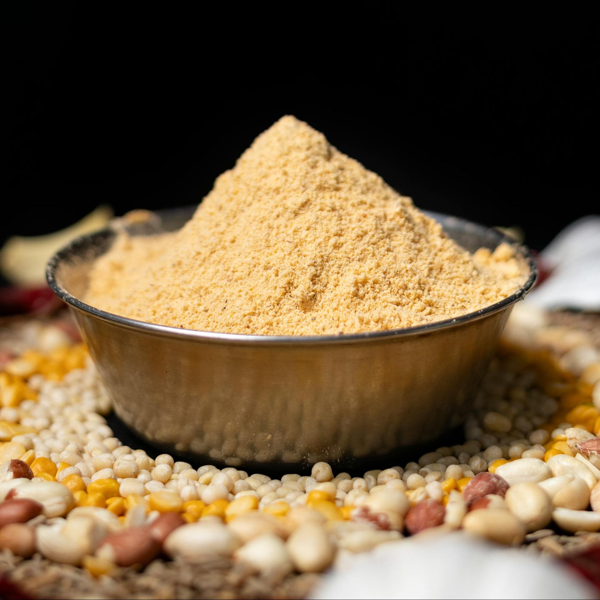 Bowl of yellow powder on a dark background