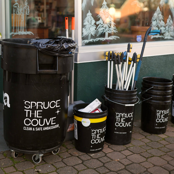 Litter pickup supplies sitting on the sidewalk in front of Kindred before an uptown cleanup event