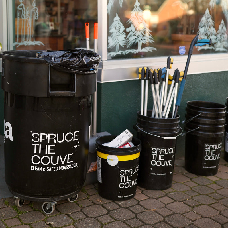 Litter pickup supplies sitting on the sidewalk in front of Kindred before an uptown cleanup event