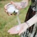 woman applying natural dry shampoo to hand