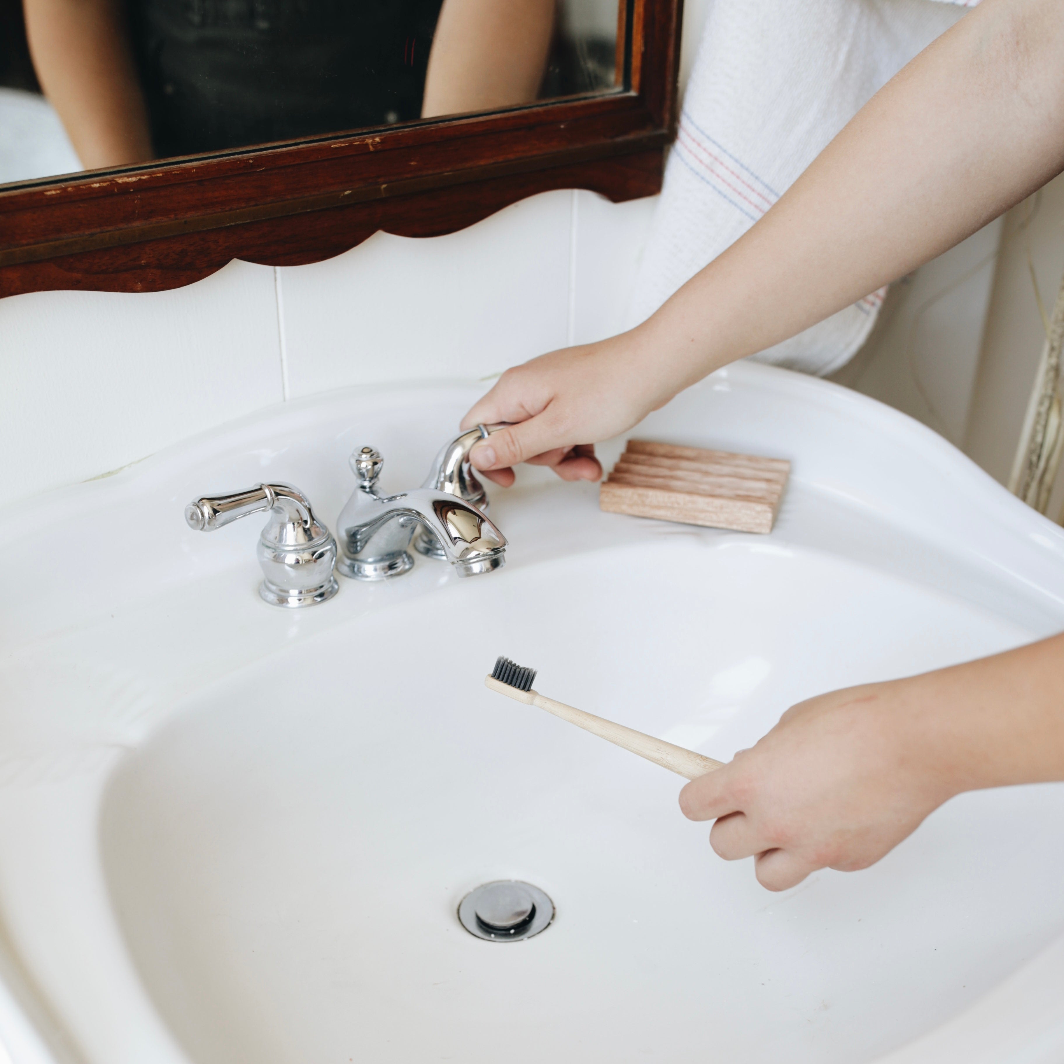 Brushing with a bamboo charcoal tooth brush-  Zero Waste Shopping at Kindred Vancouver, WA