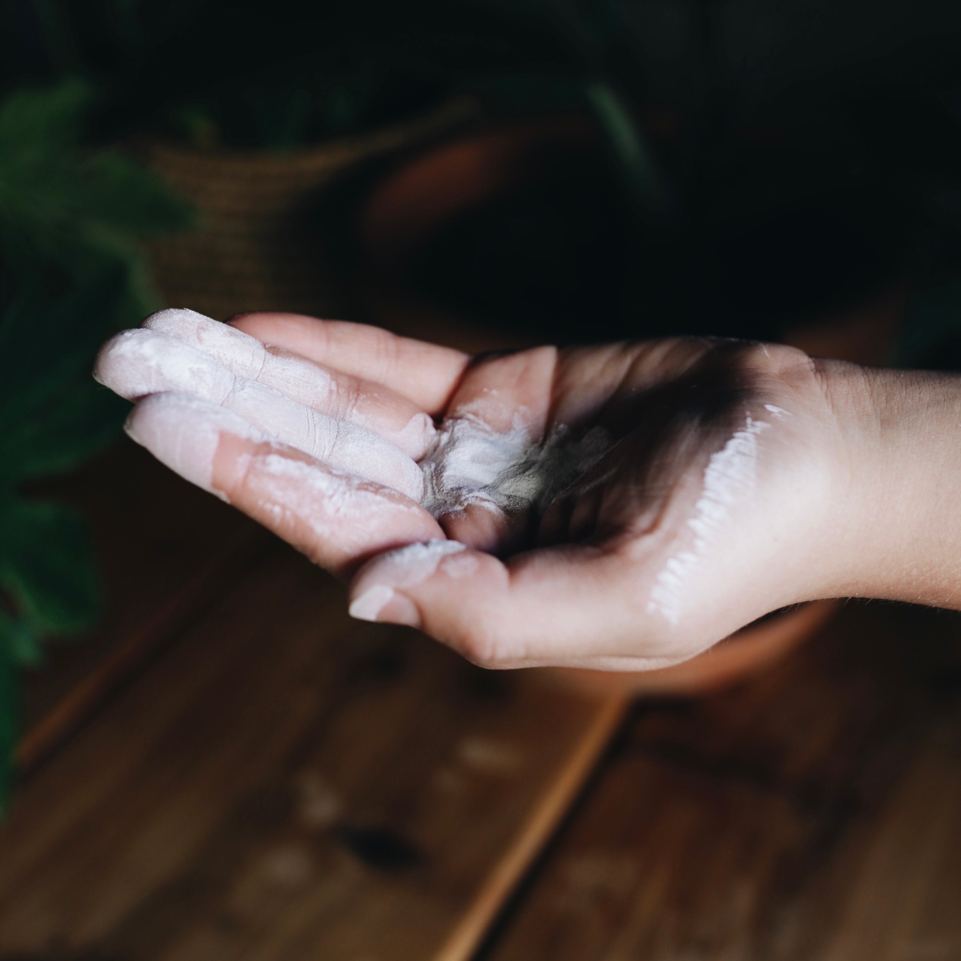 dry shampoo powder on hand